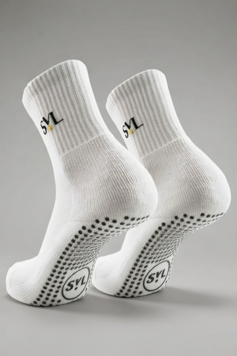 One pair of SVL white premium unisex padel grip socks showcasing the non-slip traction soles and embroidered logo.