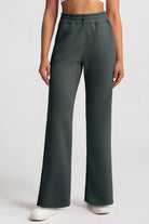 Front-facing studio shot of the dark grey Salma sweatpants featuring a comfortable wide-leg silhouette and high-waisted drawstring waistband.