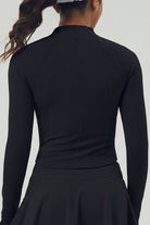 Rear view of the black Swan Sway performance jacket showing the contoured seams and aerodynamic fit for on-court movement.