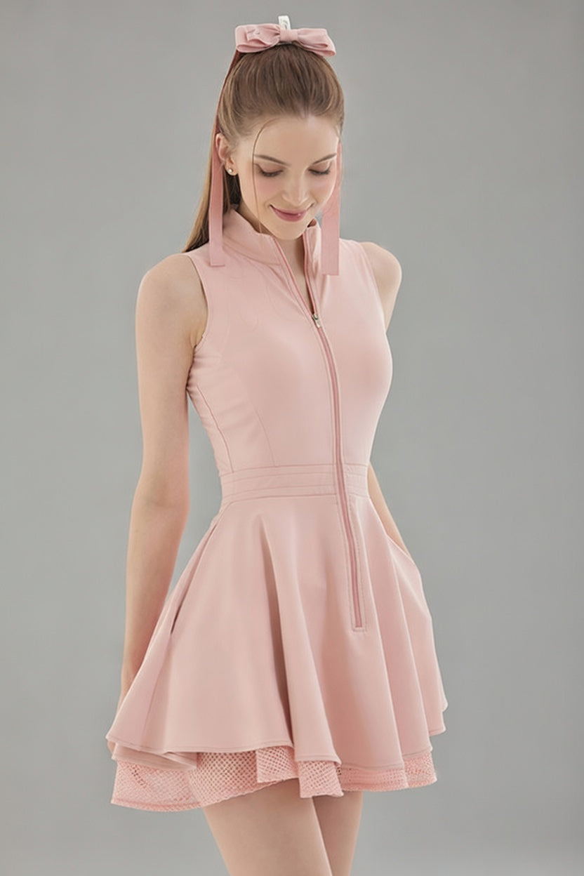 Front studio view of the pink Wiktoria tennis and padel dress featuring a high-neck zip-up bodice and a double-layered flared skirt.