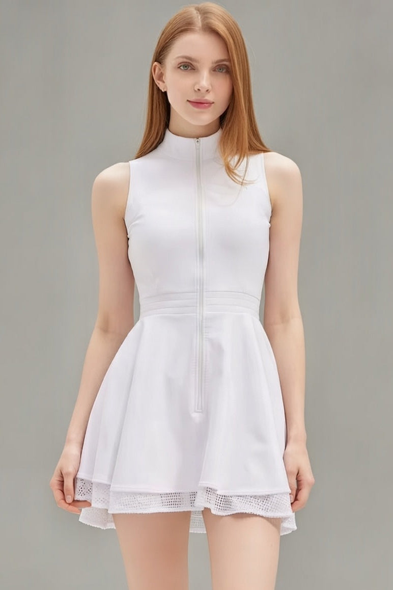 Front studio view of the white Wiktoria tennis and padel dress highlighting the functional front zipper and structured high-neck silhouette.